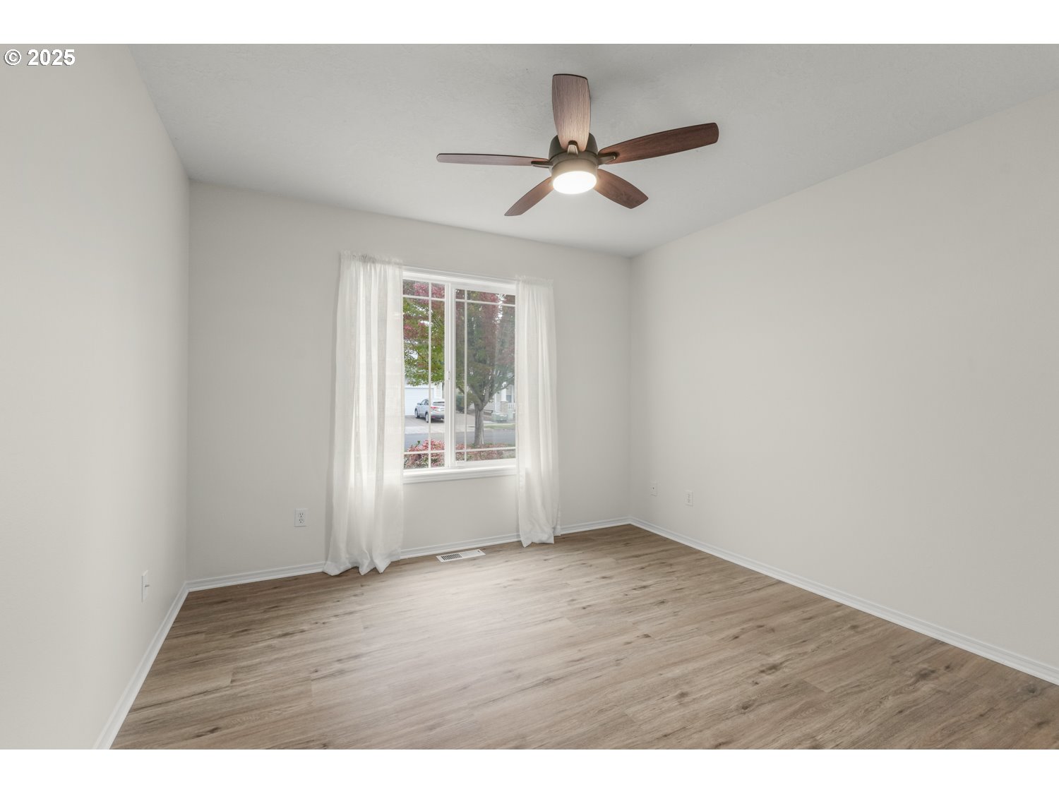 1930 Salmon Run Southwest Albany, OR 97321 - Photo 19 of 26 a view of an empty room with wooden floor and a window