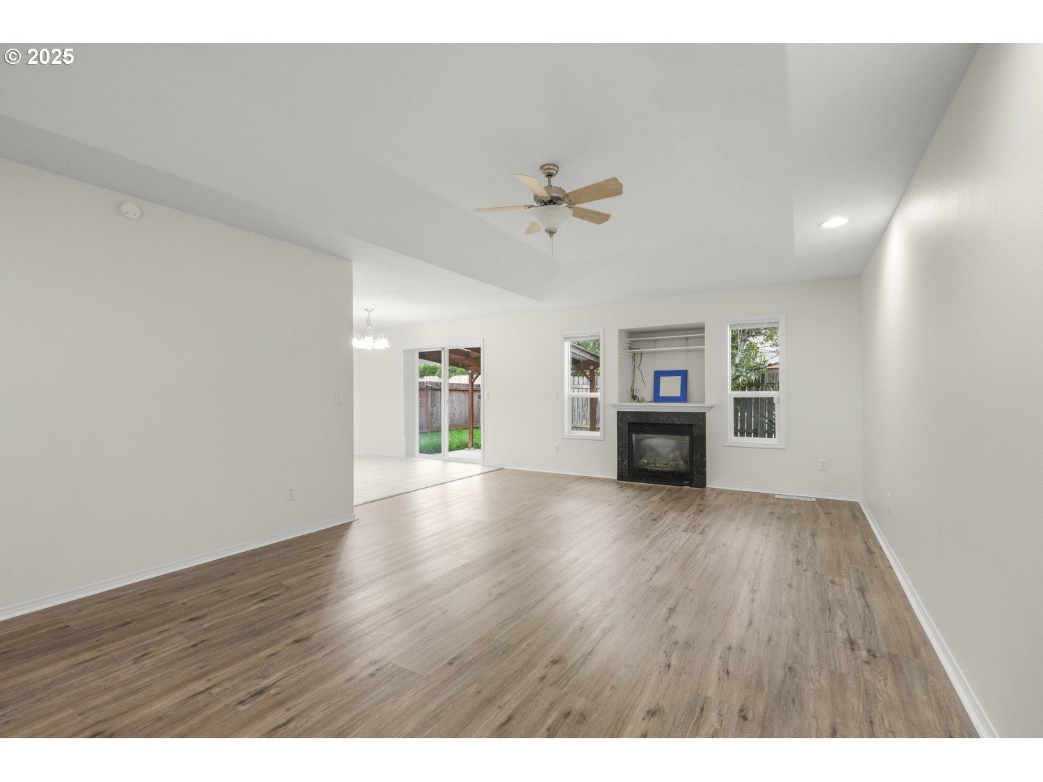 1930 Salmon Run Southwest Albany, OR 97321 - Photo 3 of 26 a view of an empty room with a fireplace and wooden floor
