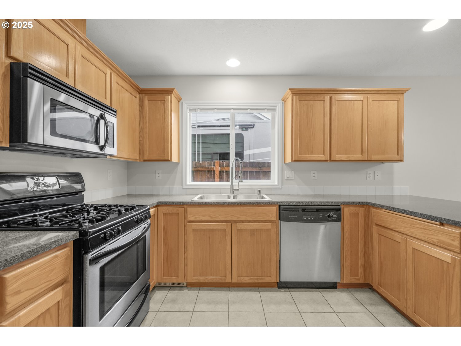 1930 Salmon Run Southwest Albany, OR 97321 - Photo 4 of 26 a kitchen with stainless steel appliances granite countertop a stove a sink and a microwave