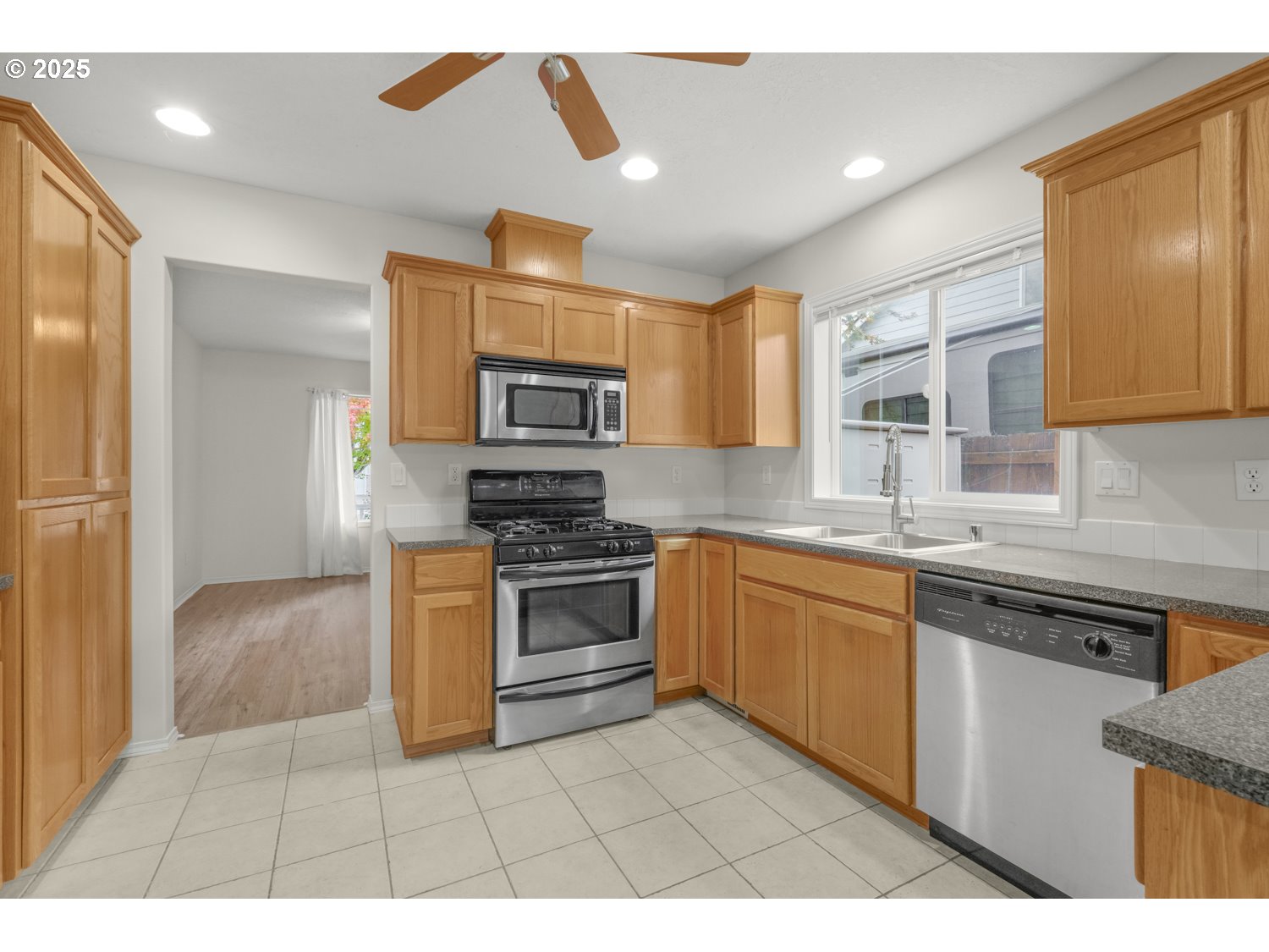 1930 Salmon Run Southwest Albany, OR 97321 - Photo 5 of 26 a kitchen with stainless steel appliances granite countertop a sink and a stove