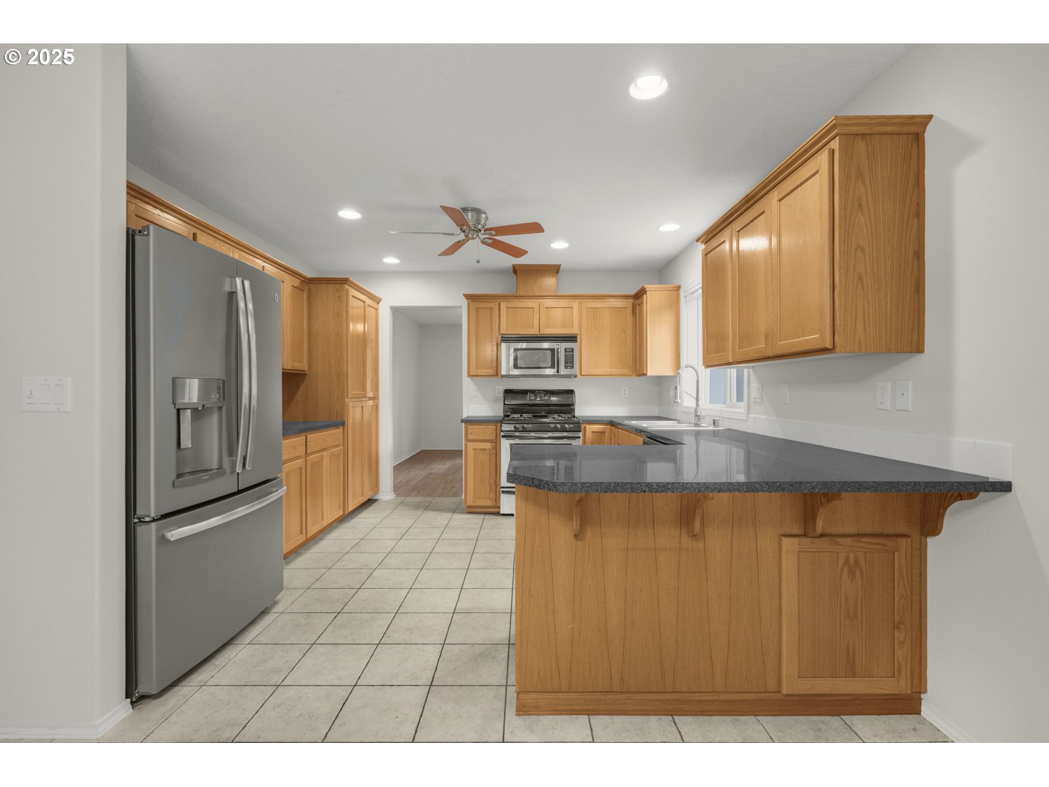 1930 Salmon Run Southwest Albany, OR 97321 - Photo 8 of 26 a kitchen with stainless steel appliances granite countertop a refrigerator a sink and a stove