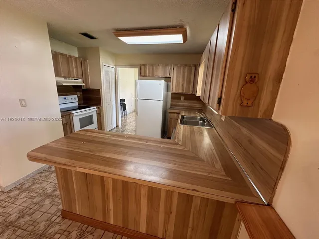 a kitchen with a refrigerator and a stove