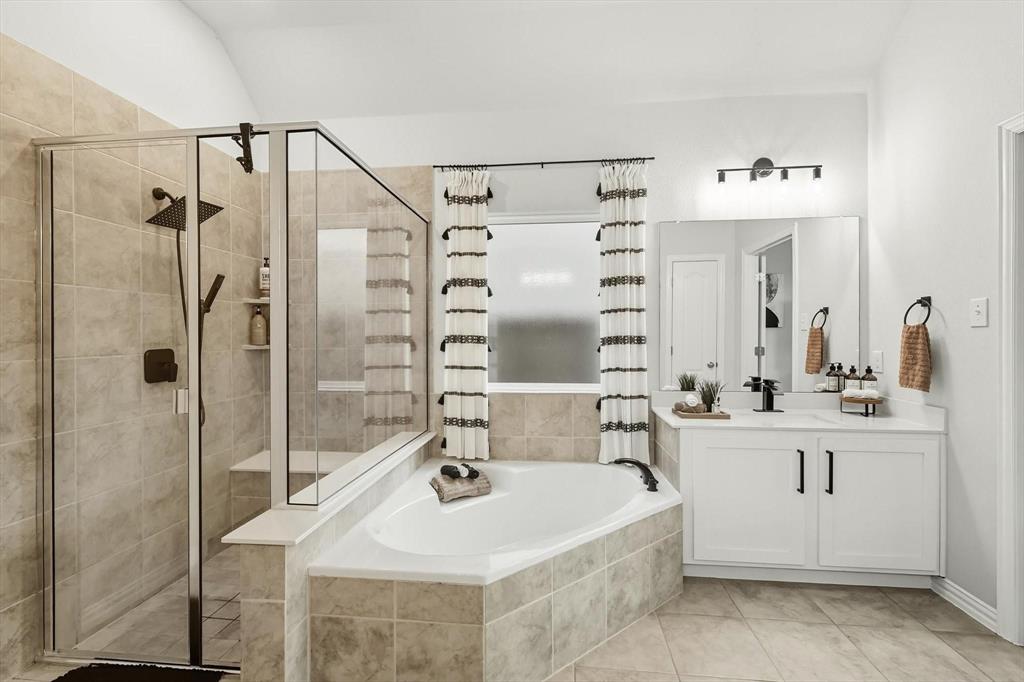 1724 Wassel Road Fort Worth, TX 76052 - Photo 12 of 24 Contemporary bathroom featuring a walk-in shower with bench seating, a separate soaking tub, and a single vanity with a large mirror and modern lighting