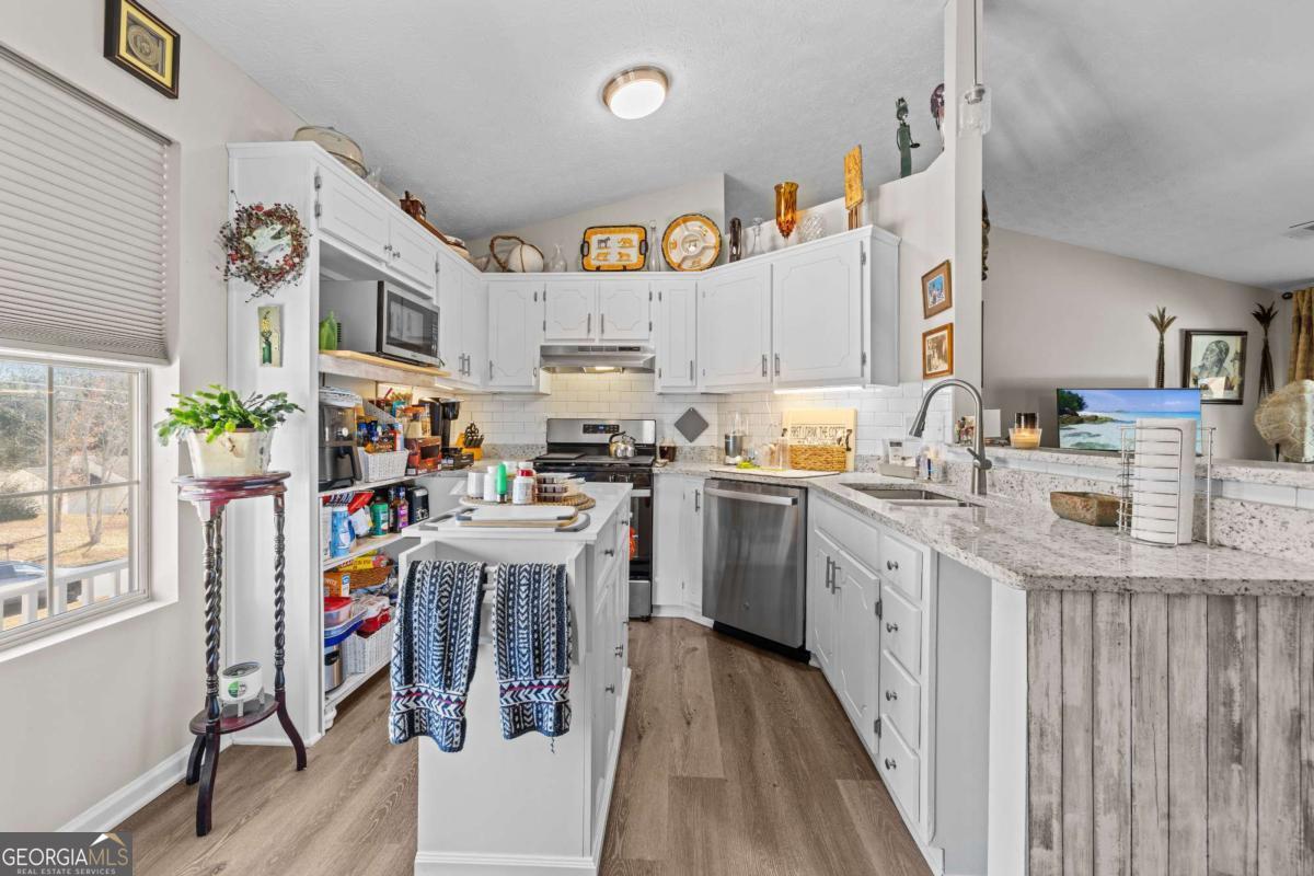6324 Amberly Road Rex, GA 30273 - Photo 12 of 22 a kitchen with cabinets and wooden floor
