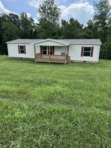a view of a house with backyard porch and furniture