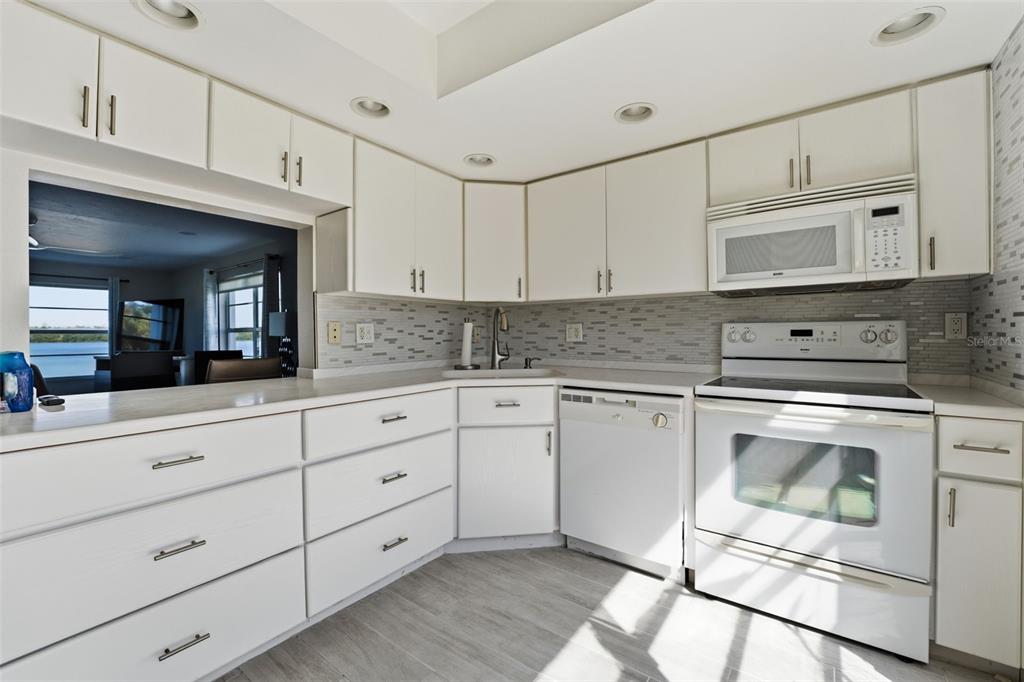4440 Exeter Drive, Unit 106 Longboat Key, FL 34228 - Photo 4 of 26 a kitchen with granite countertop cabinets stainless steel appliances and a sink