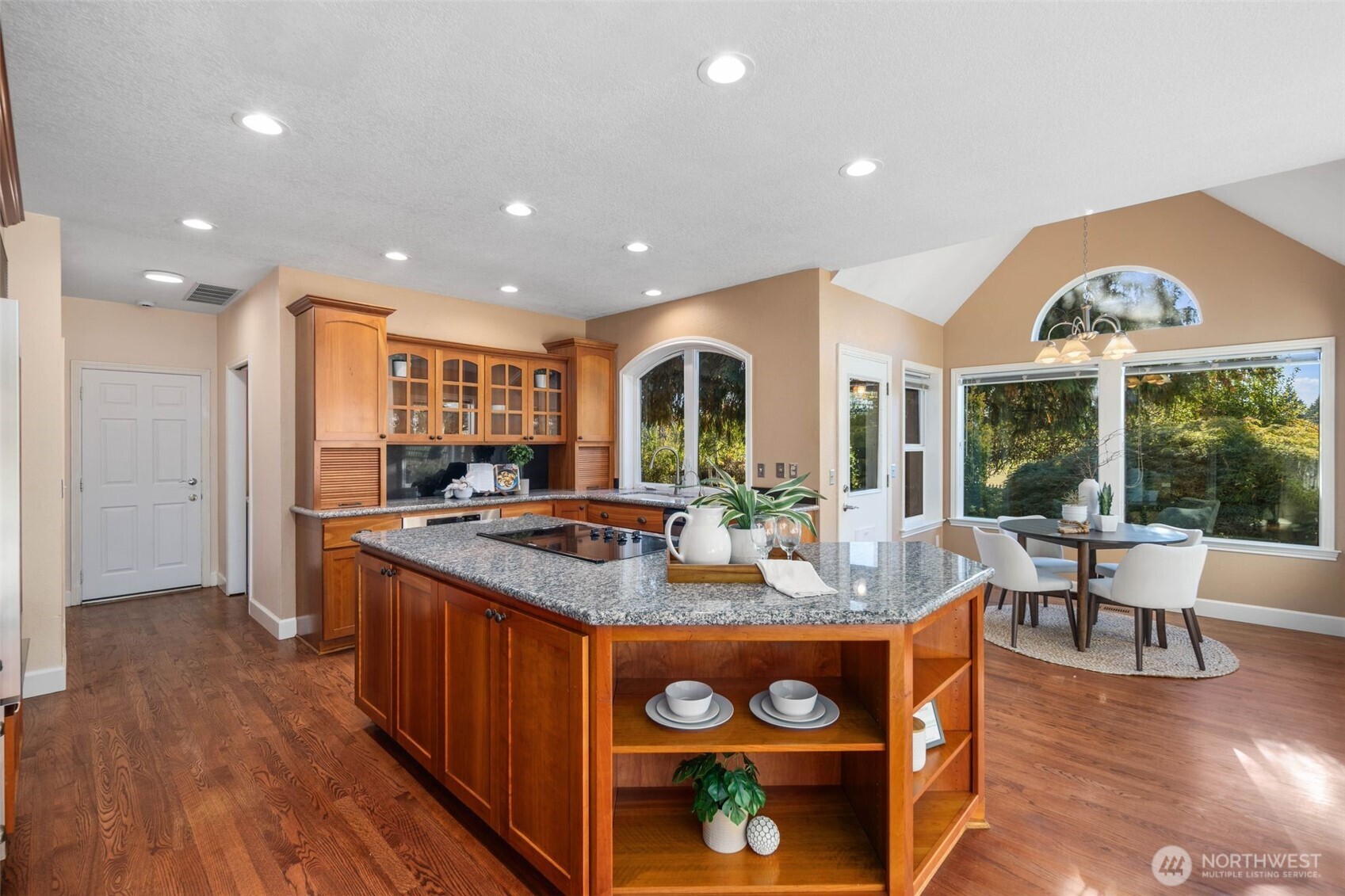 16104 Northeast 6th Court Ridgefield, WA 98642 - Photo 14 of 40 a kitchen with stainless steel appliances granite countertop a stove and a wooden floors