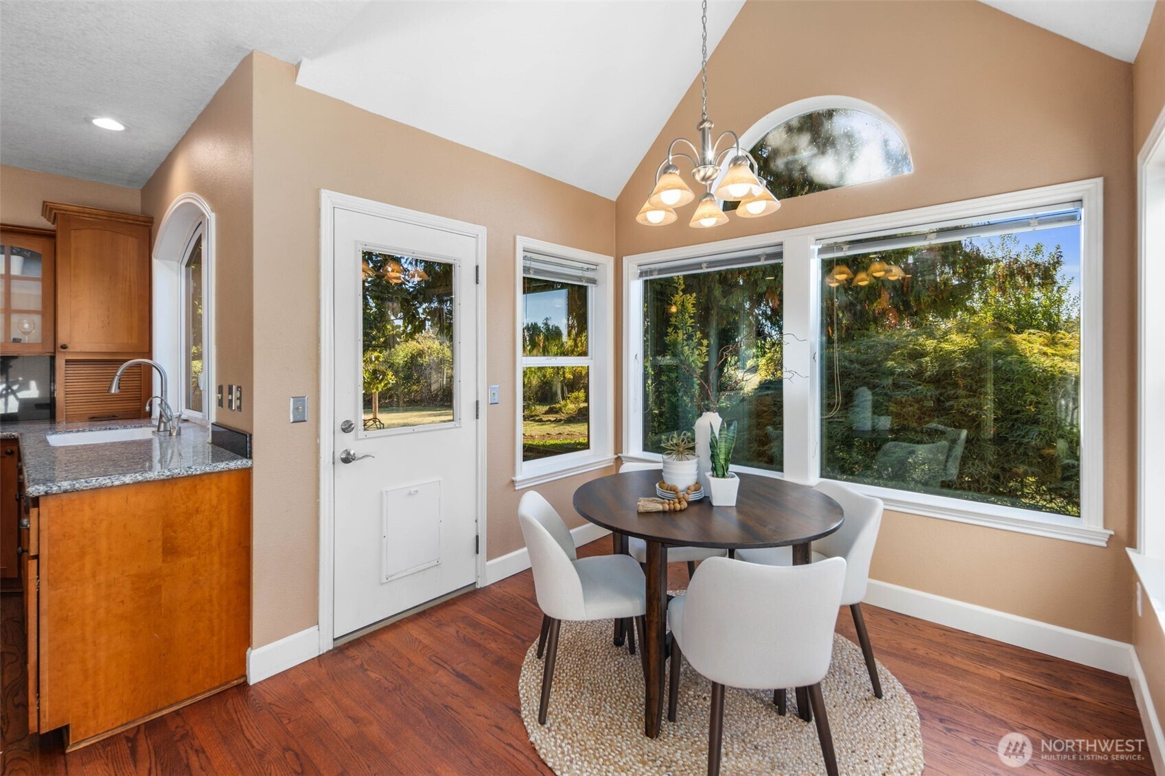 16104 Northeast 6th Court Ridgefield, WA 98642 - Photo 19 of 40 a view of a dining room with furniture large windows and wooden floor