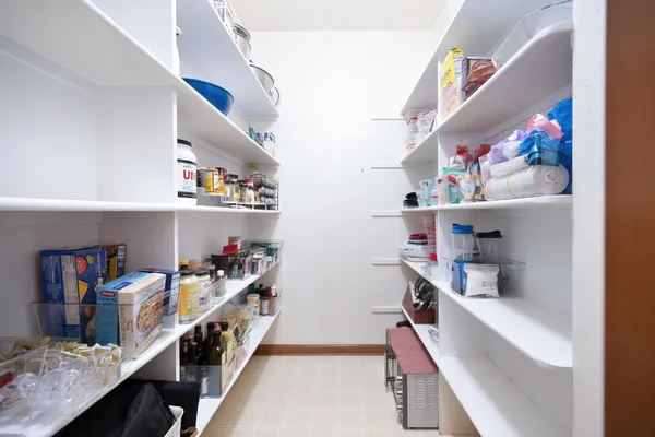 a storage room with lots of clutter and cabinets