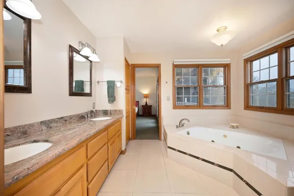 a spacious bathroom with a granite countertop tub and a sink