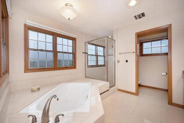 a bathroom with a tub and a shower
