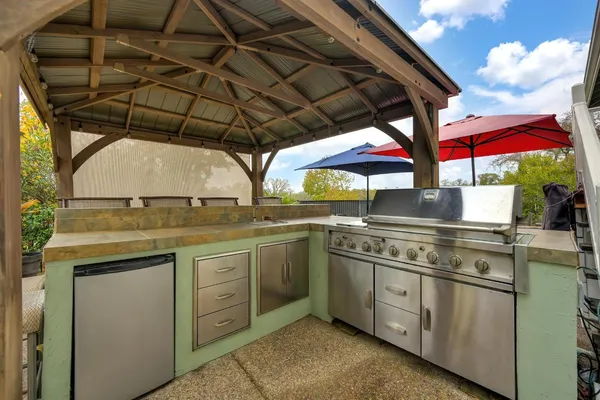 a kitchen with stainless steel appliances granite countertop a sink and a stove