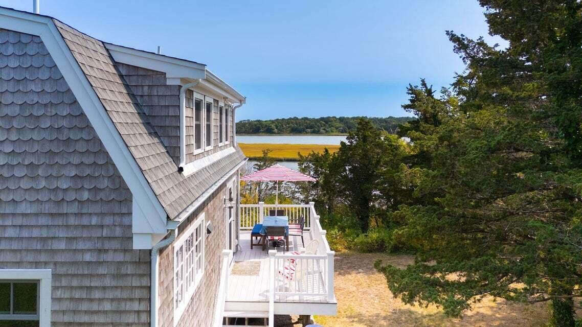 63 Briar Spring Road Orleans, MA 02653 - Photo 21 of 37 a view of a tall building with a floor to ceiling window