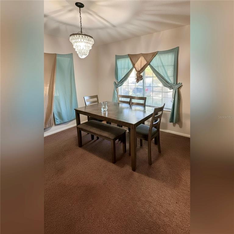 10801 Brickside Court Riverview, FL 33579 - Photo 4 of 16 a view of a dining room with furniture and wooden floor
