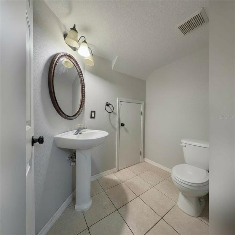 10801 Brickside Court Riverview, FL 33579 - Photo 7 of 16 a bathroom with a sink toilet and a mirror