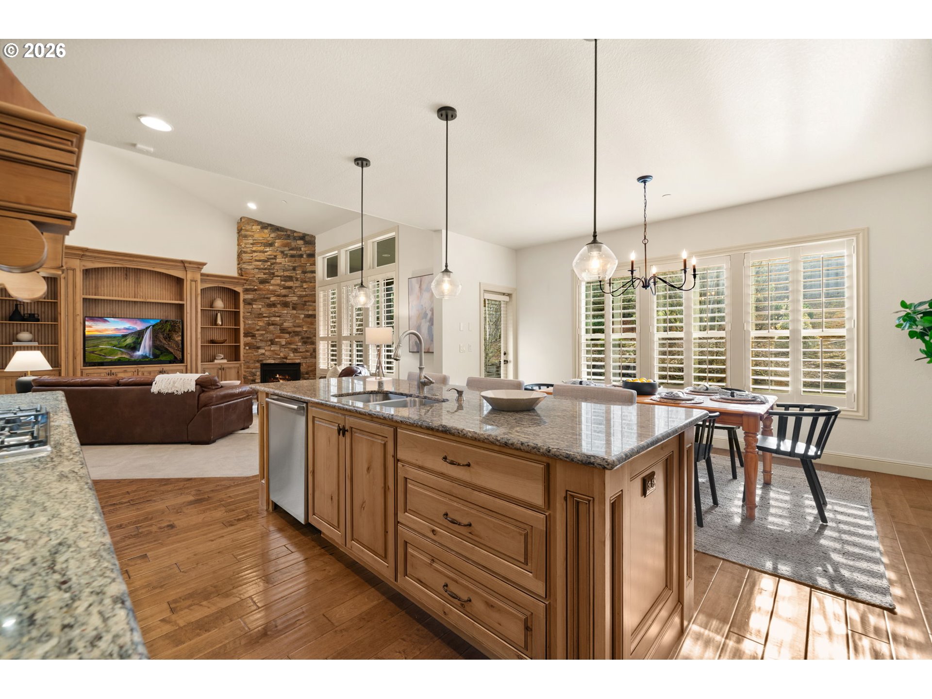 1406 Northwest 44th Avenue Camas, WA 98607 - Photo 14 of 48 a open kitchen with kitchen island granite countertop a sink table and chairs