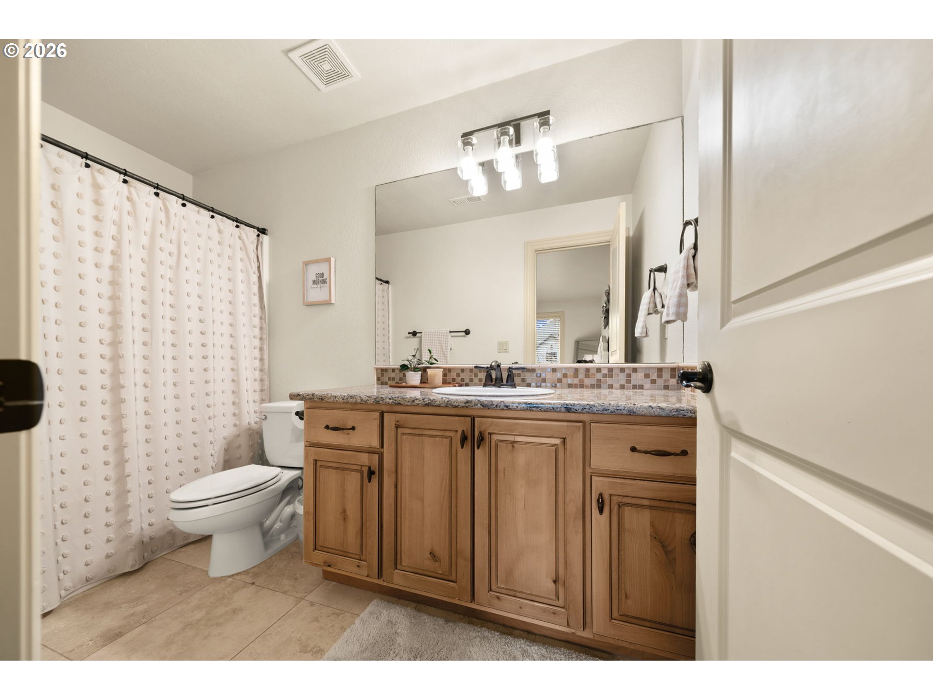 1406 Northwest 44th Avenue Camas, WA 98607 - Photo 27 of 48 a bathroom with a granite countertop sink a toilet a mirror and shower curtain