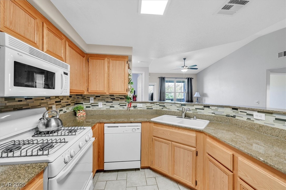 Kitchen featuring decorative backsplash & light tile patterned flooring