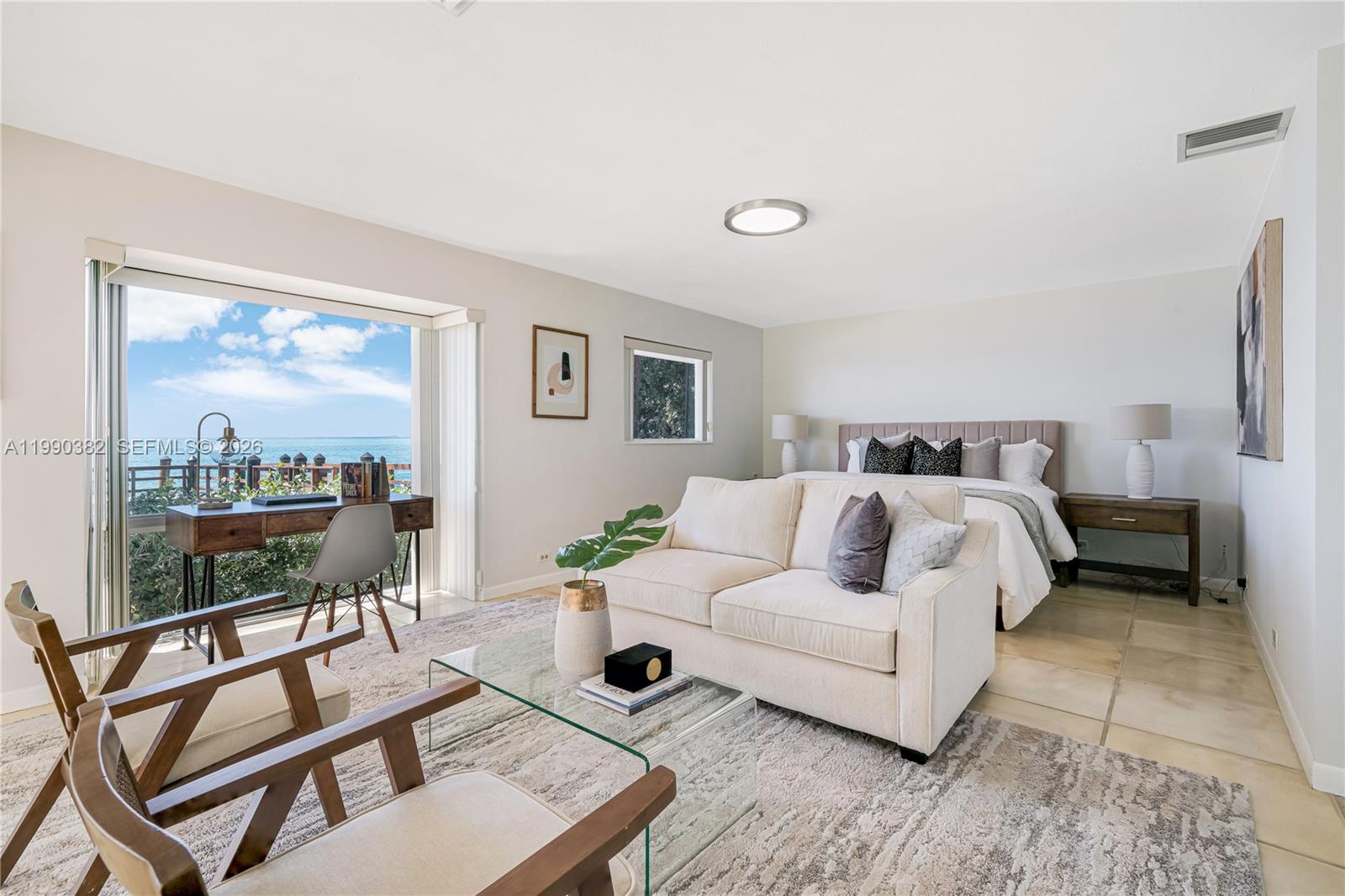 640 South Mashta Drive Key Biscayne, FL 33149 - Photo 14 of 38 a bedroom with a bed a glass top table and a large window