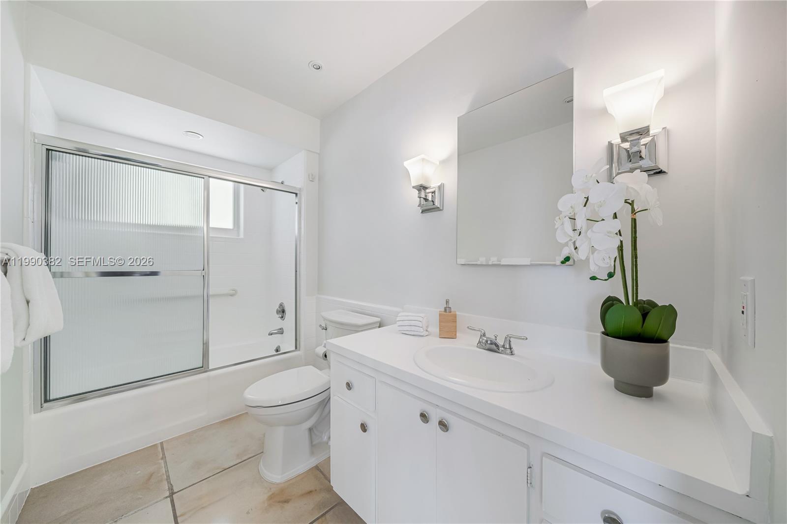 640 South Mashta Drive Key Biscayne, FL 33149 - Photo 17 of 38 a bathroom with a granite countertop sink a toilet and shower