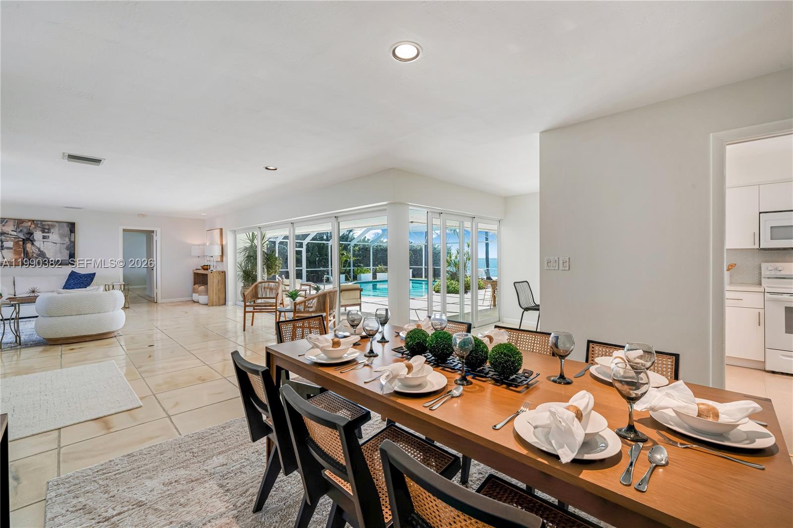 640 South Mashta Drive Key Biscayne, FL 33149 - Photo 20 of 38 a dining room with furniture large windows and wooden floor