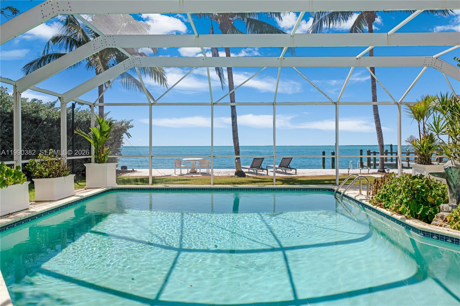 640 South Mashta Drive Key Biscayne, FL 33149 - Photo 23 of 38 a view of a swimming pool with a patio and a yard