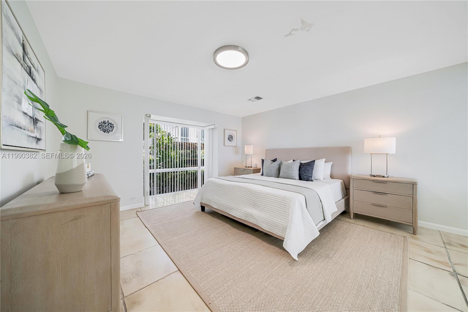 640 South Mashta Drive Key Biscayne, FL 33149 - Photo 28 of 38 a spacious bedroom with a bed and window