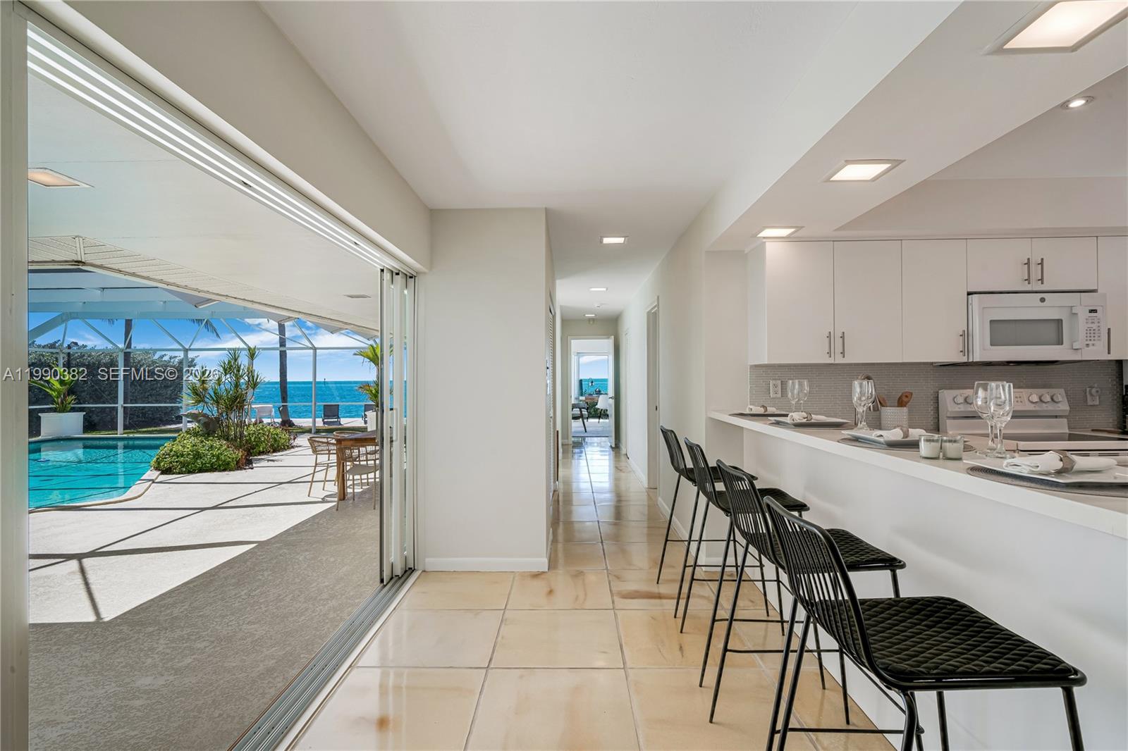 640 South Mashta Drive Key Biscayne, FL 33149 - Photo 37 of 38 a kitchen with a table and chairs in it