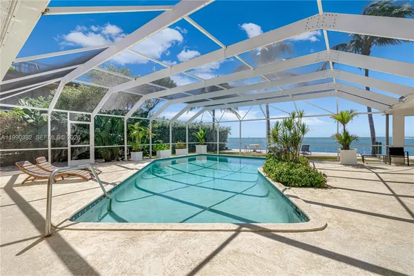 an aerial view of a house with outdoor space pool table and chairs