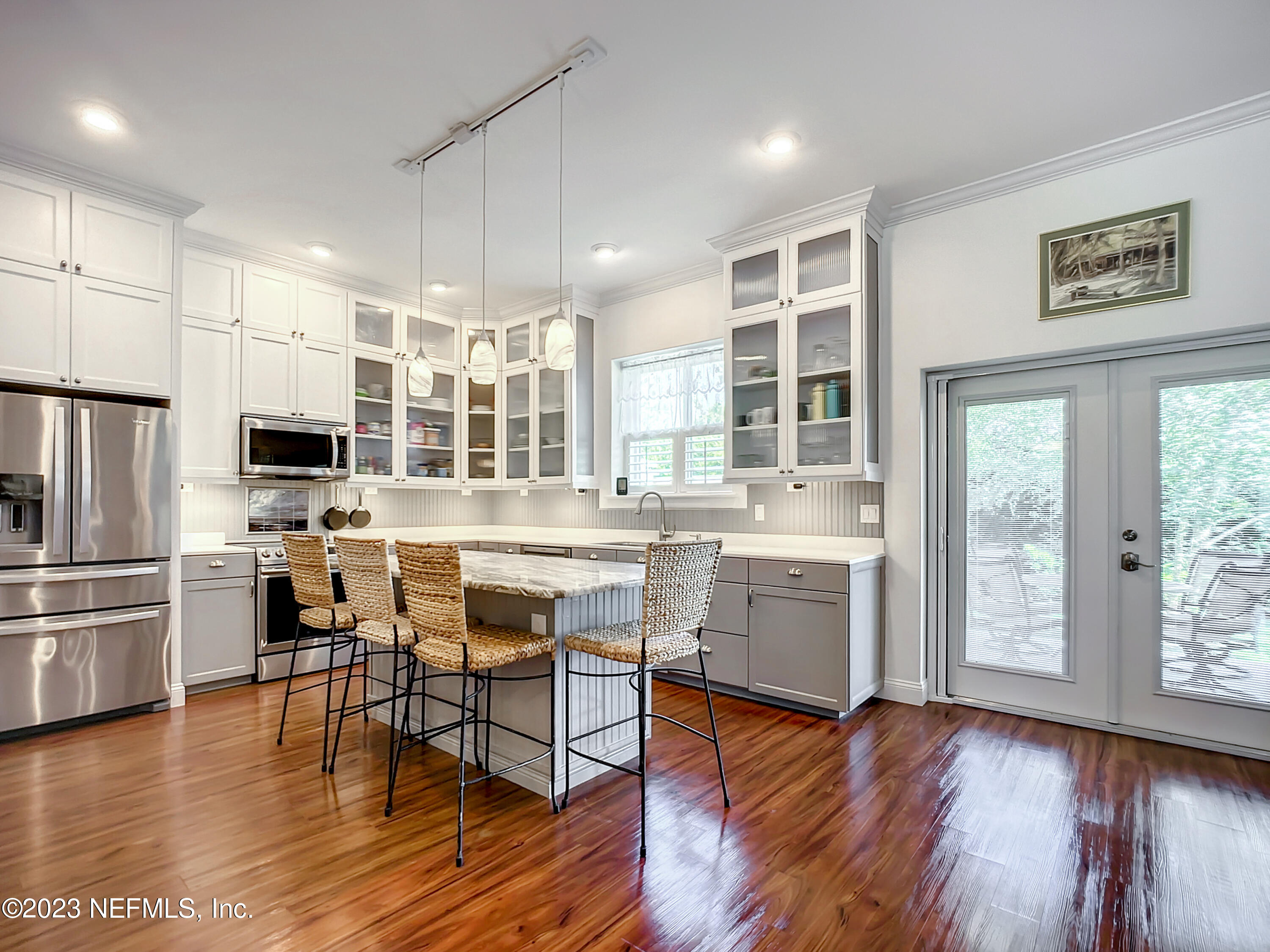 5356 2nd Street St. Augustine, FL 32080 - Photo 11 of 60 a kitchen with a table chairs refrigerator and cabinets