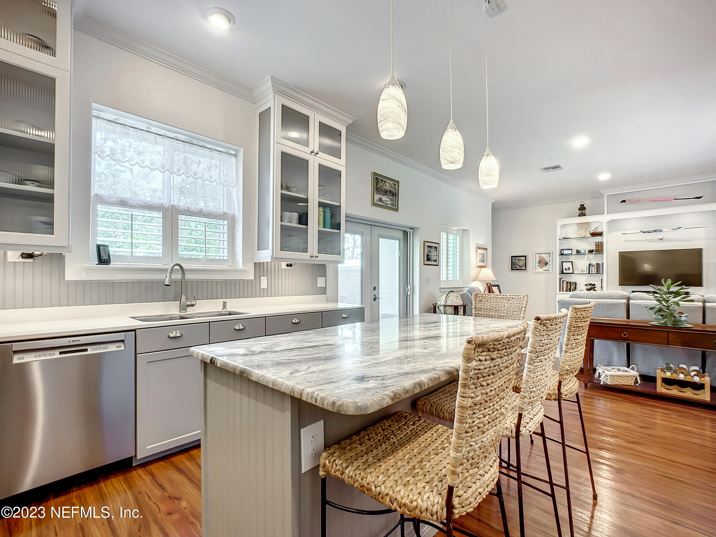 5356 2nd Street St. Augustine, FL 32080 - Photo 12 of 60 a kitchen with stainless steel appliances granite countertop a stove top oven a sink a dining table and chairs