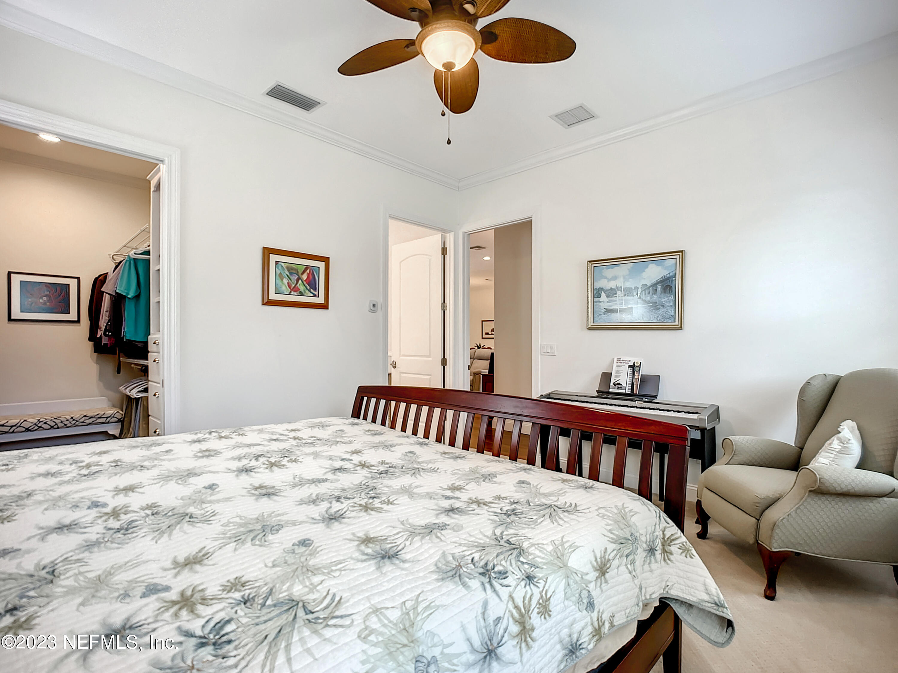 5356 2nd Street St. Augustine, FL 32080 - Photo 20 of 60 a bedroom with a bed a couch and a chandelier