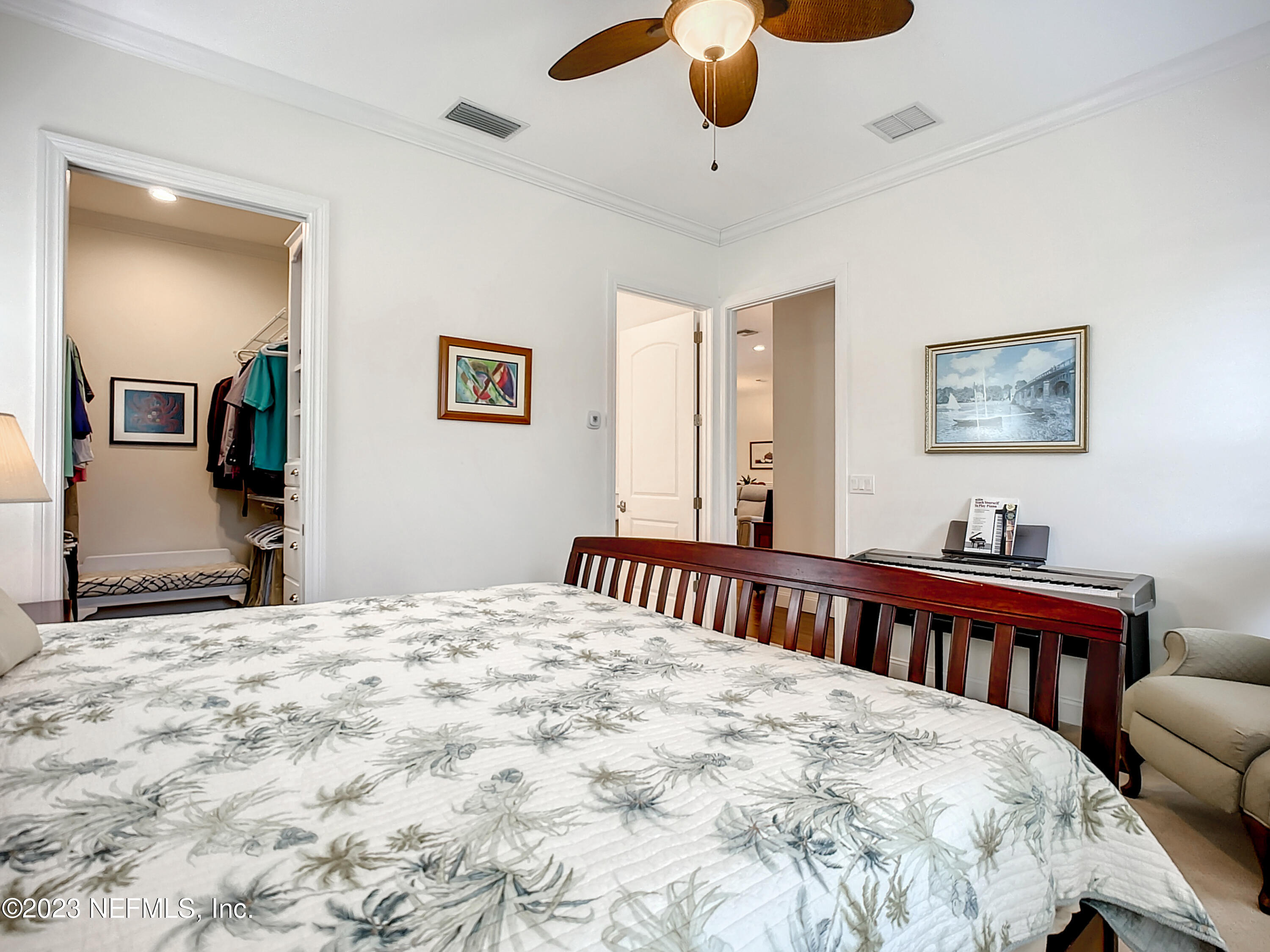 5356 2nd Street St. Augustine, FL 32080 - Photo 21 of 60 a bedroom with a bed and a chandelier
