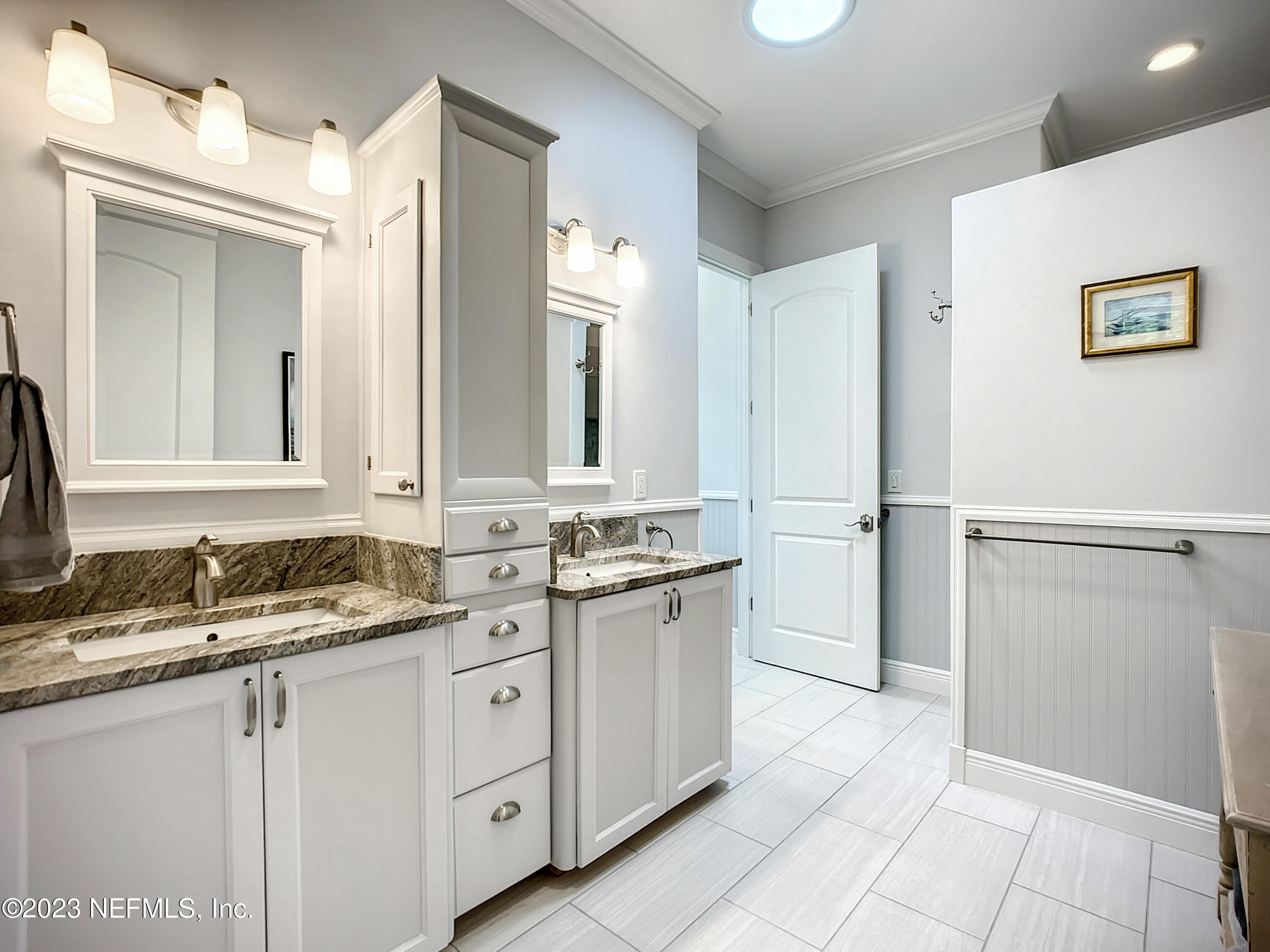 5356 2nd Street St. Augustine, FL 32080 - Photo 26 of 60 a bathroom with a granite countertop sink and a mirror