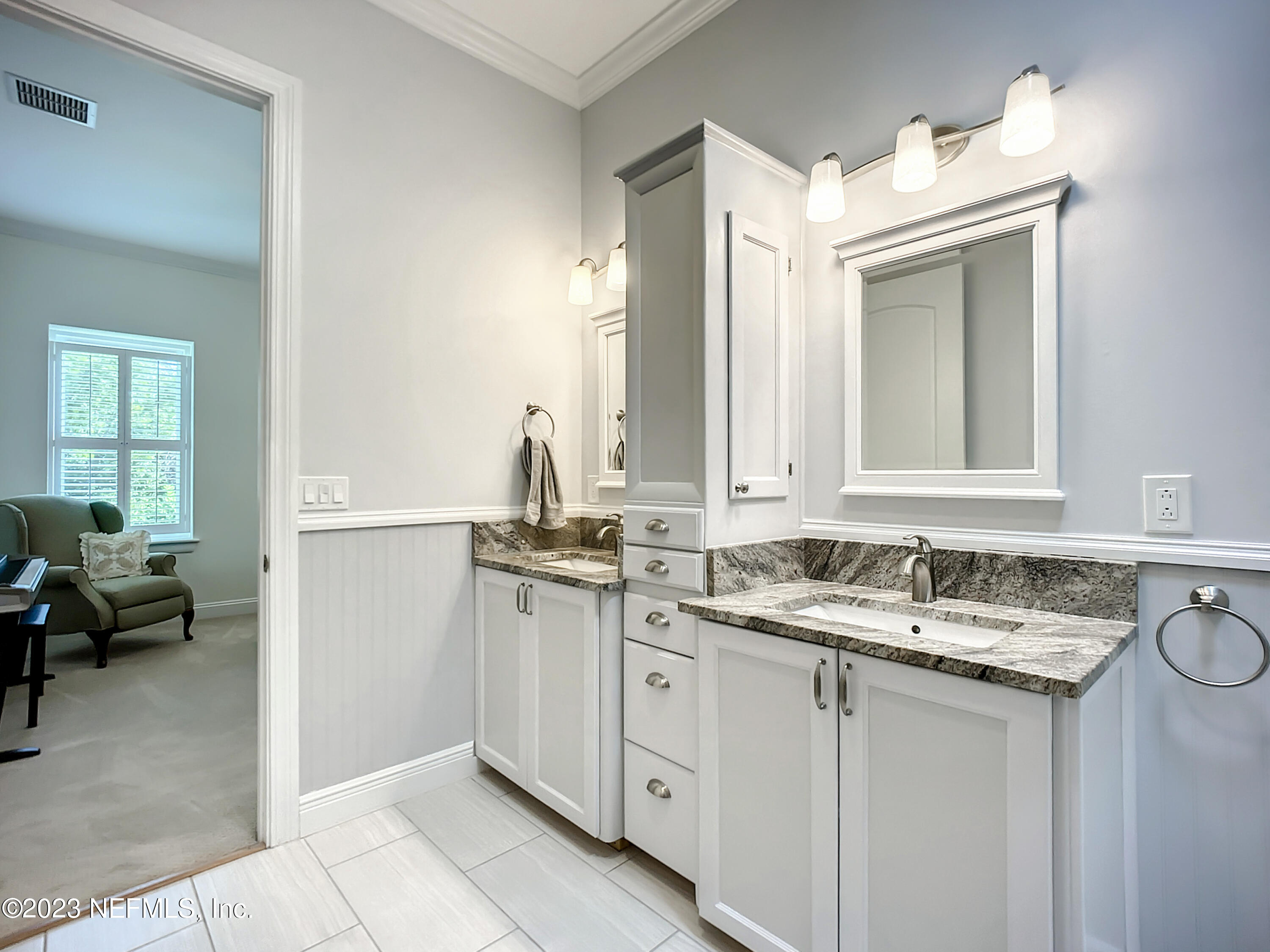 5356 2nd Street St. Augustine, FL 32080 - Photo 27 of 60 a bathroom with a sink and a mirror