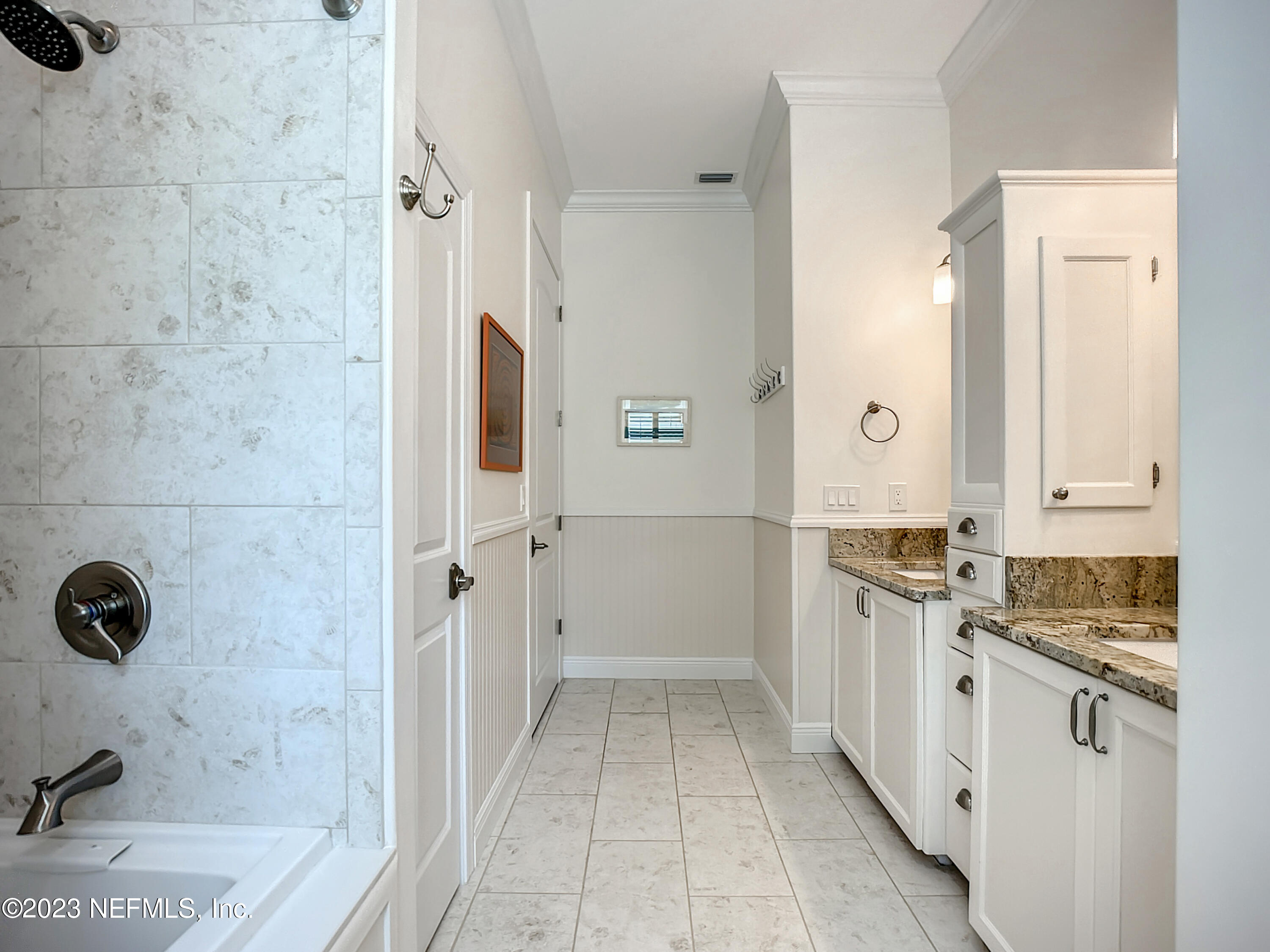 5356 2nd Street St. Augustine, FL 32080 - Photo 38 of 60 a bathroom with a granite countertop sink a mirror and shower