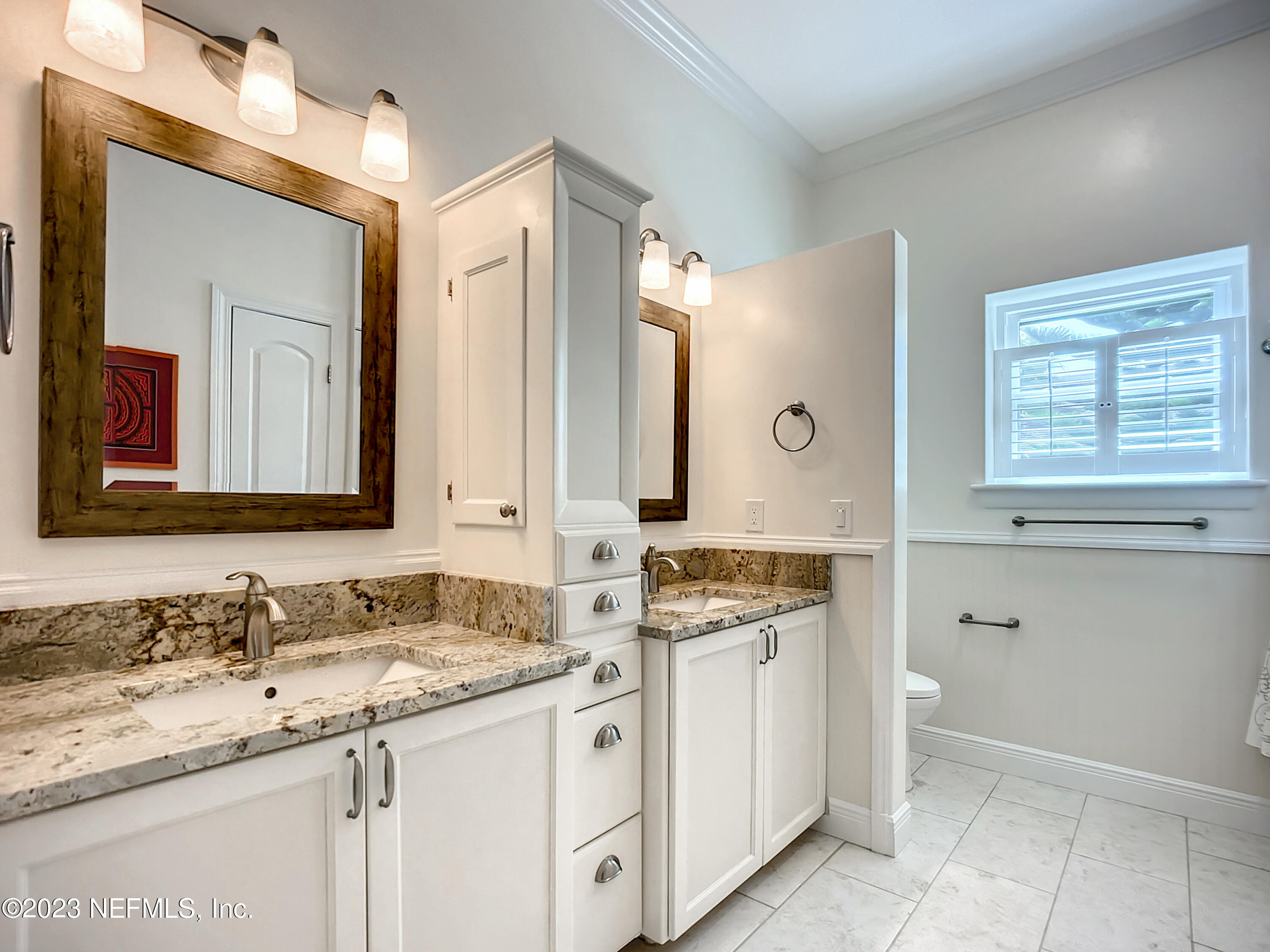 5356 2nd Street St. Augustine, FL 32080 - Photo 40 of 60 a bathroom with a granite countertop double vanity sink and mirror
