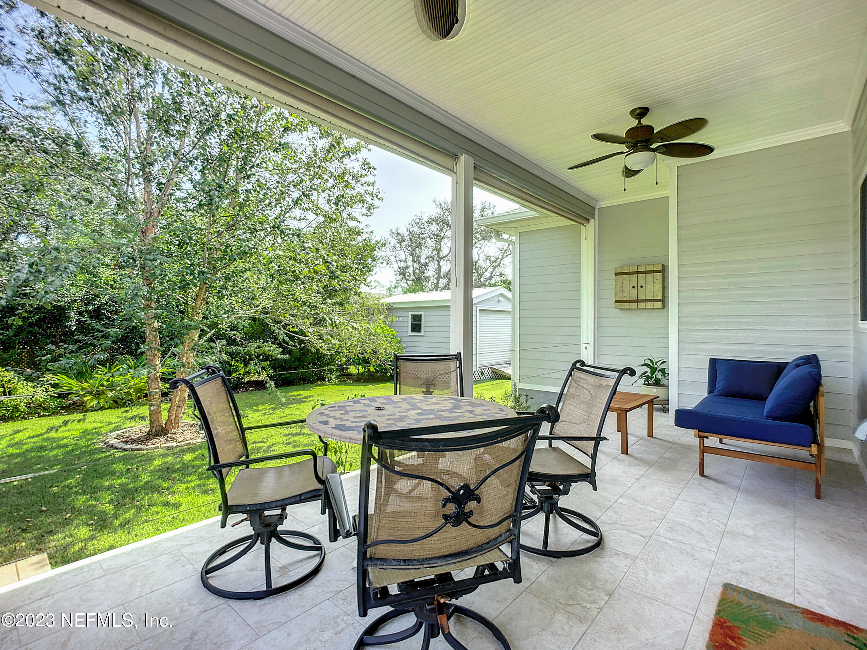 5356 2nd Street St. Augustine, FL 32080 - Photo 50 of 60 a view of patio with table and chairs and a yard