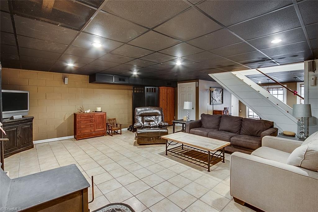 306 Charlie S Road Robbins, NC 27325 - Photo 20 of 30 Recreation room in basement, ceramic tile floor & wood stove