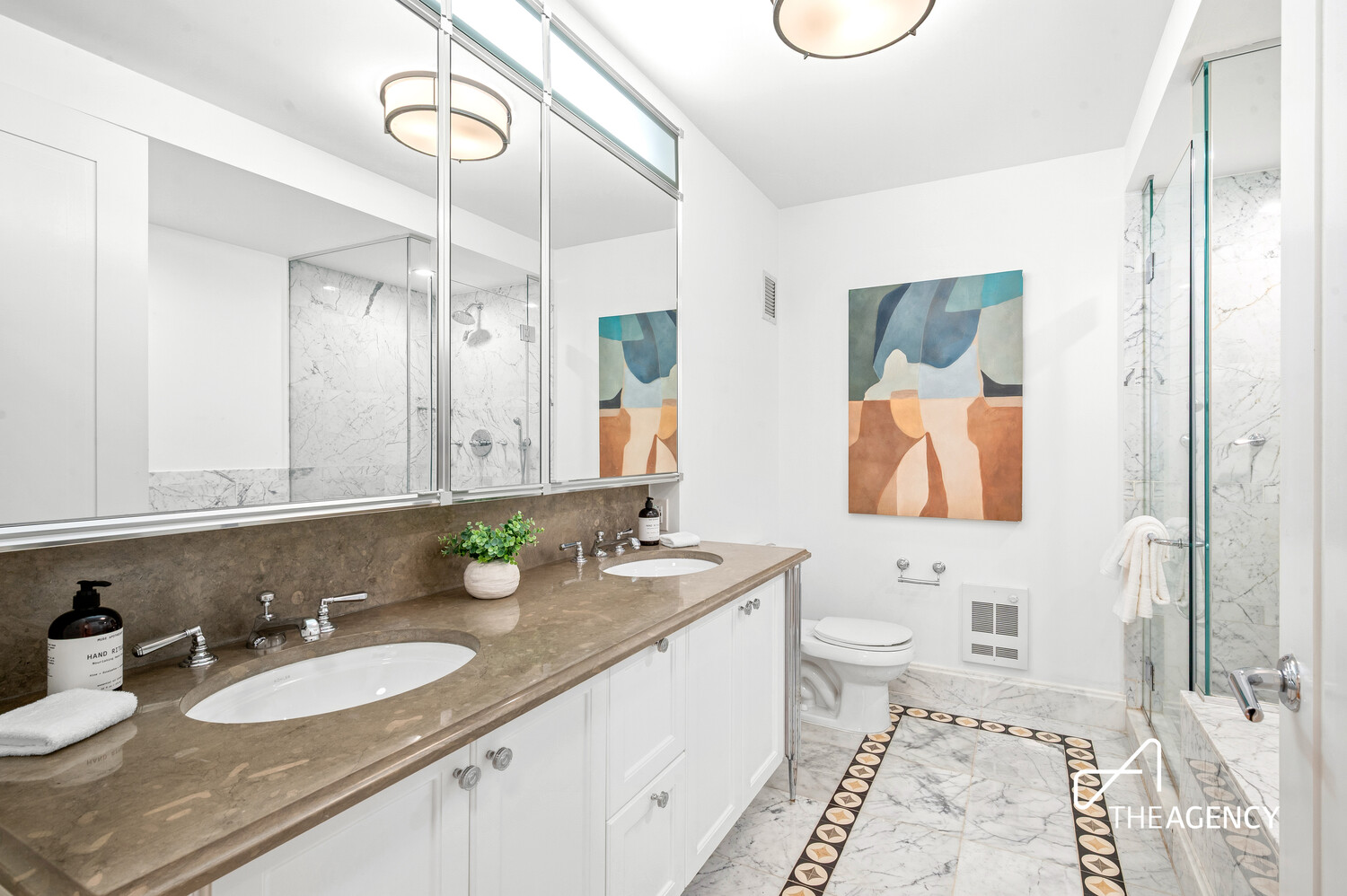 205 West 76th Street, Unit 1202 Manhattan, NY 10023 - Photo 7 of 11 a bathroom with a granite countertop sink mirror and a