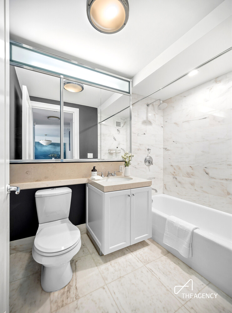 205 West 76th Street, Unit 1202 Manhattan, NY 10023 - Photo 9 of 11 a bathroom with a toilet a sink and a bathtub