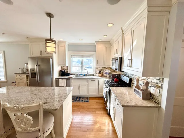 a living room with furniture flat screen tv and a fireplace