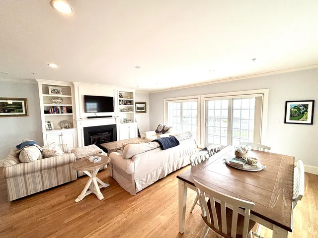 a living room with furniture and large windows