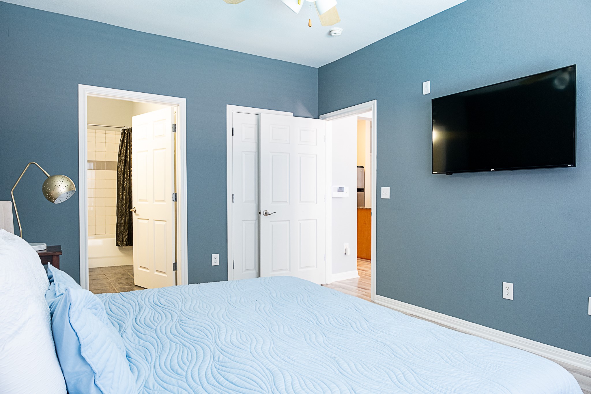 2502 Leon Street, Unit 309 Austin, TX 78705 - Photo 16 of 19 a bedroom with a bed and a flat screen tv