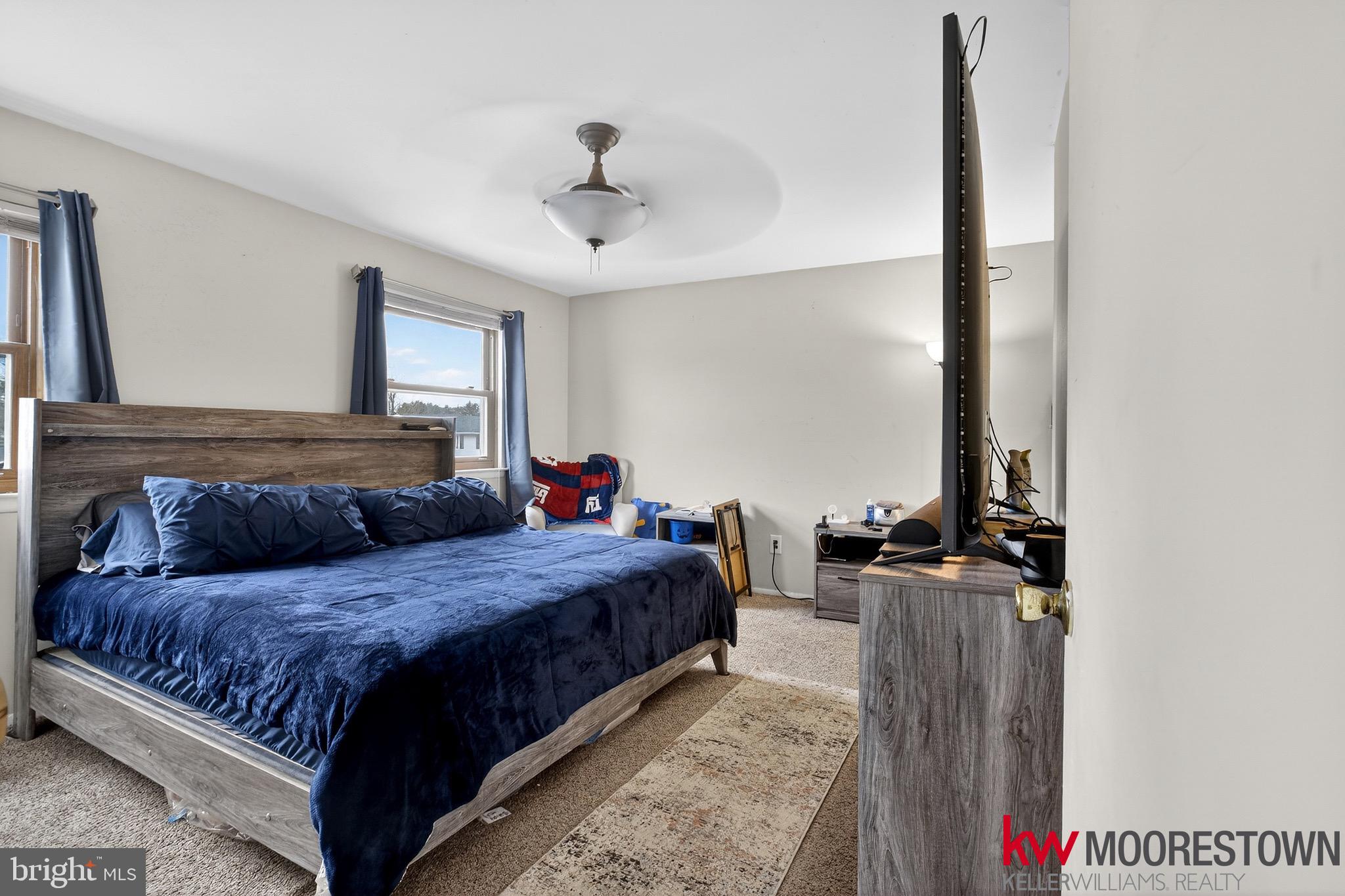 19 Nottingham Way Eastampton, NJ 08060 - Photo 29 of 44 a bedroom with a large bed and a chandelier