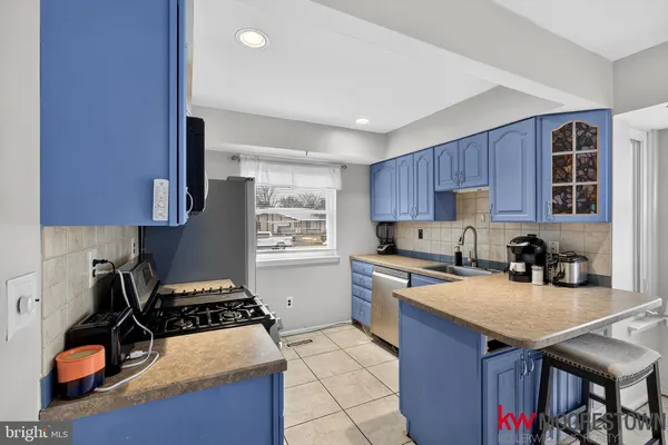 a kitchen with a stove a sink and a refrigerator