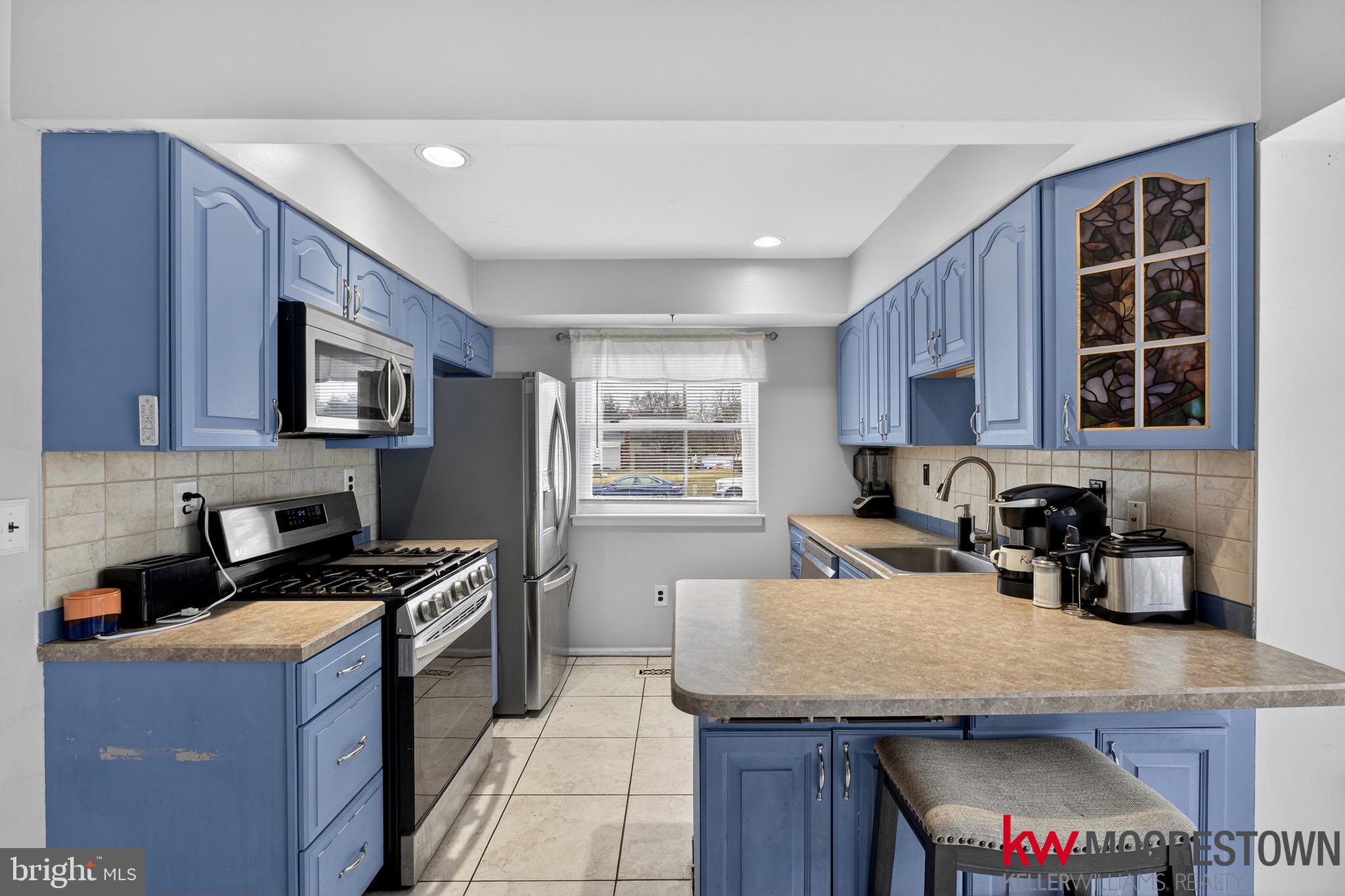 19 Nottingham Way Eastampton, NJ 08060 - Photo 9 of 44 a kitchen with granite countertop a stove a sink a refrigerator and wooden cabinets