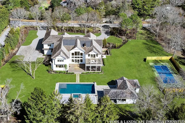 an aerial view of a house with outdoor space and lake view
