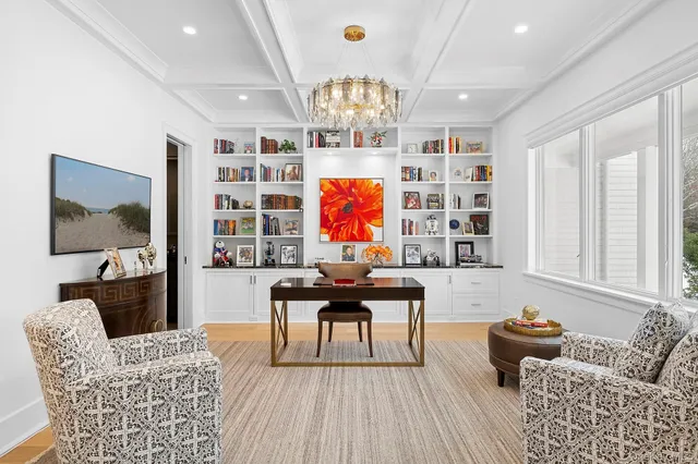 a living room with furniture a rug and a chandelier