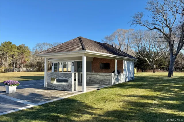 a backyard of a house with table and chairs